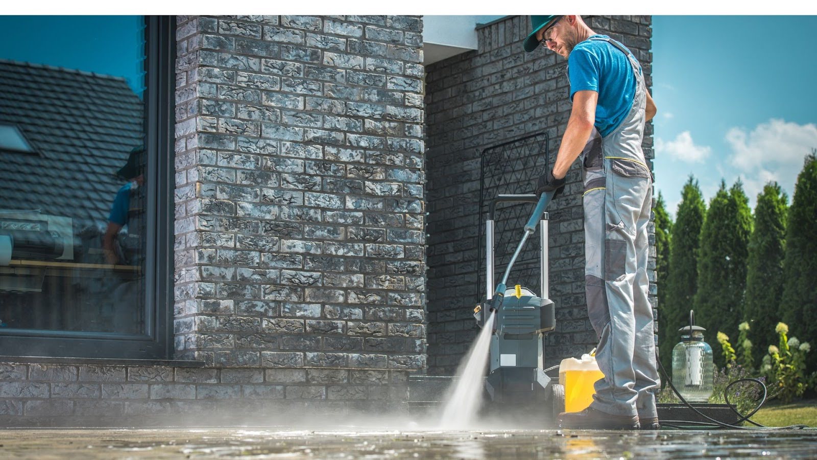 Professional pressure cleaning in action, with focused water jets revitalising the appearance of brickwork surfaces.